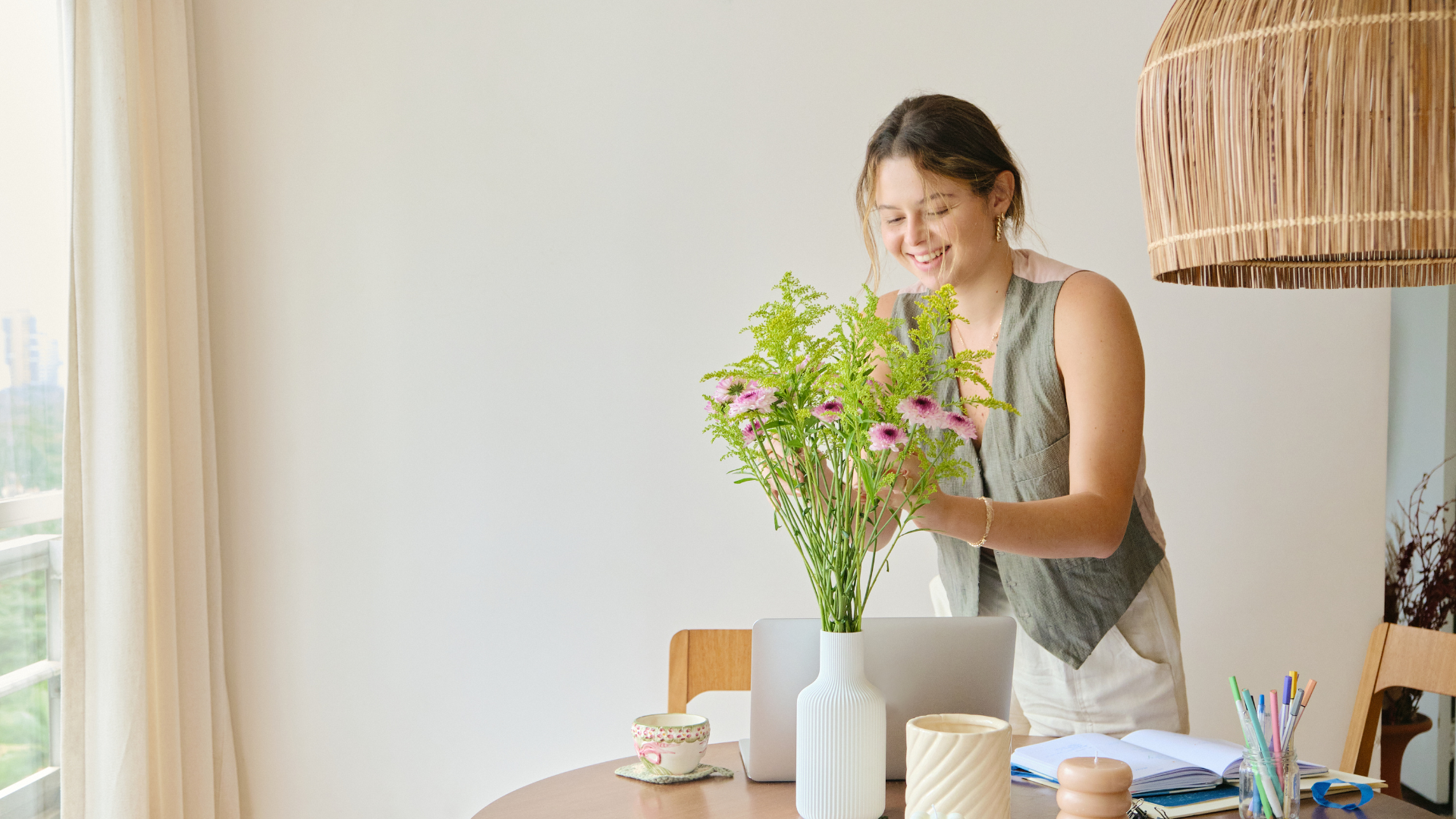 A beautifully styled living room with fresh flowers and stylish decor.