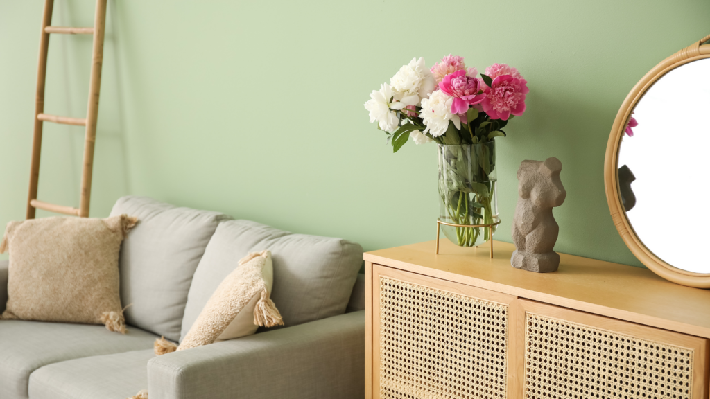 A stylish and clean photoshoot location with fresh flowers and neatly arranged decor.