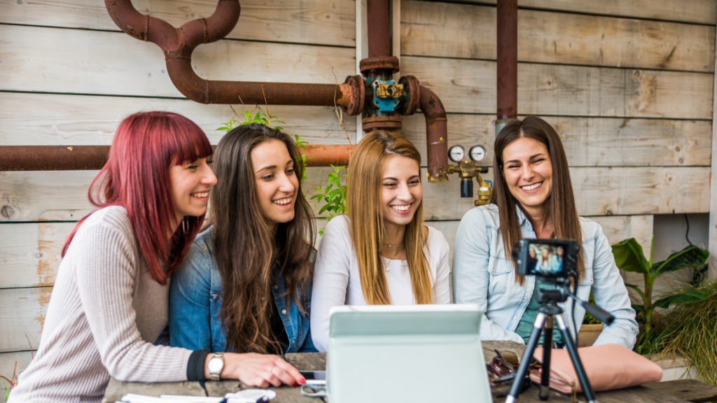 Female influencers filming content to promote a location on social media.