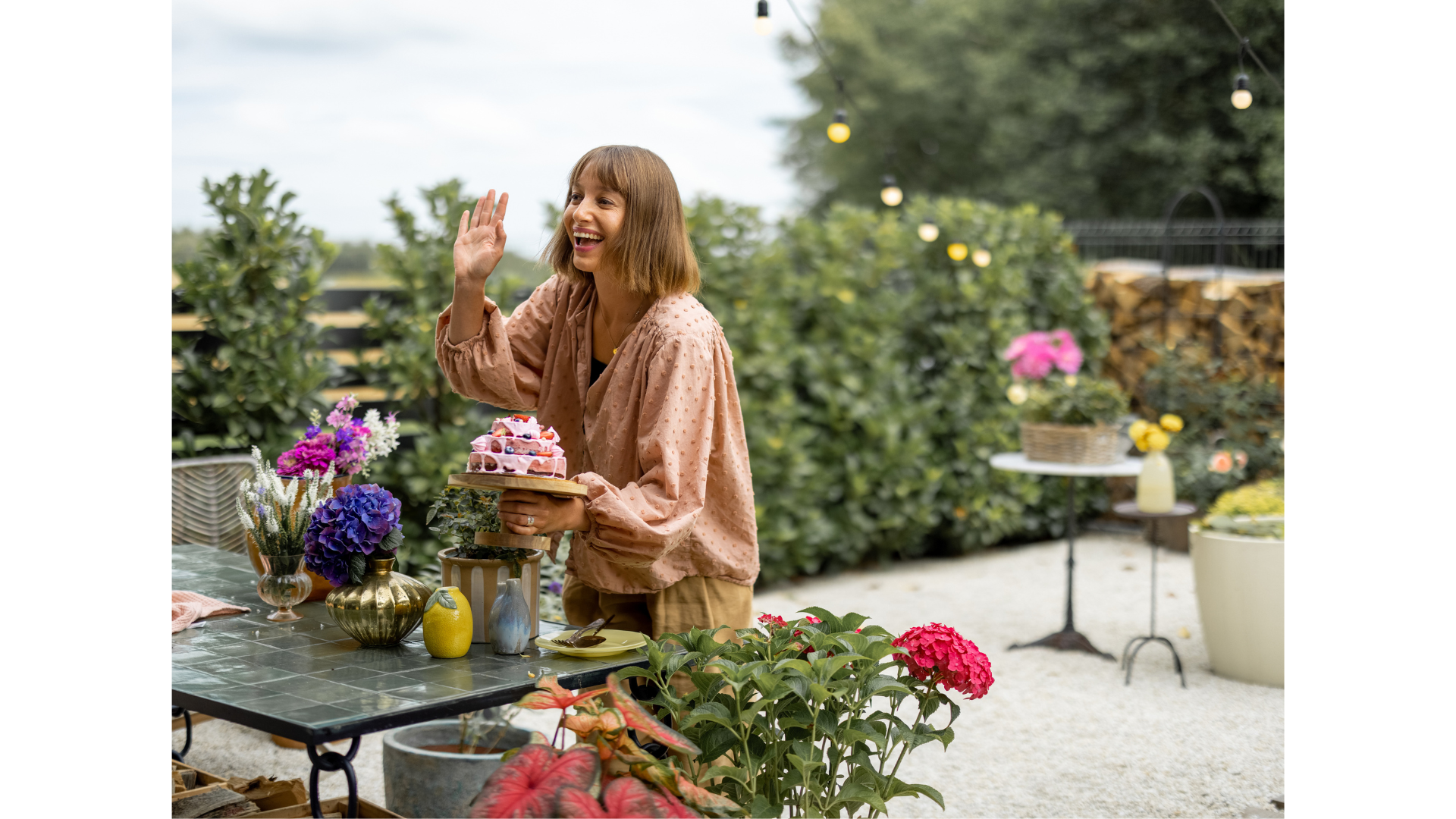 A rustic garden area with tables and flowering plants, perfect for outdoor shoots.